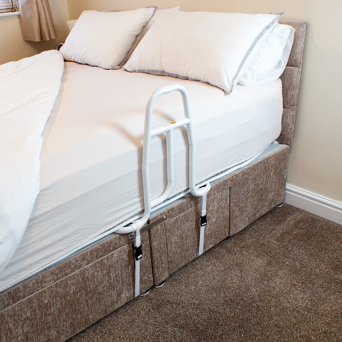 Full view of NRS EasyFit Bed Grab Rail grab rail with circular wall plates and a textured grip, designed to provide support in bathrooms and other areas.
