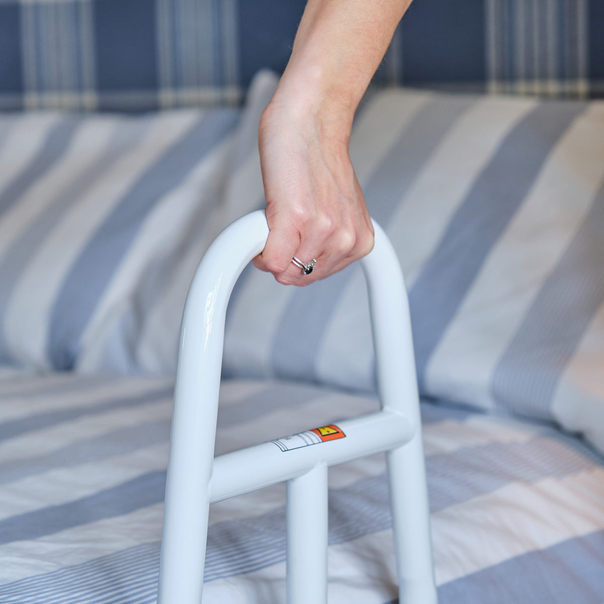 NRS EasyFit Bed Grab Rail installed next to a bath, shower or toilet, illustrating how it offers extra support and stability.