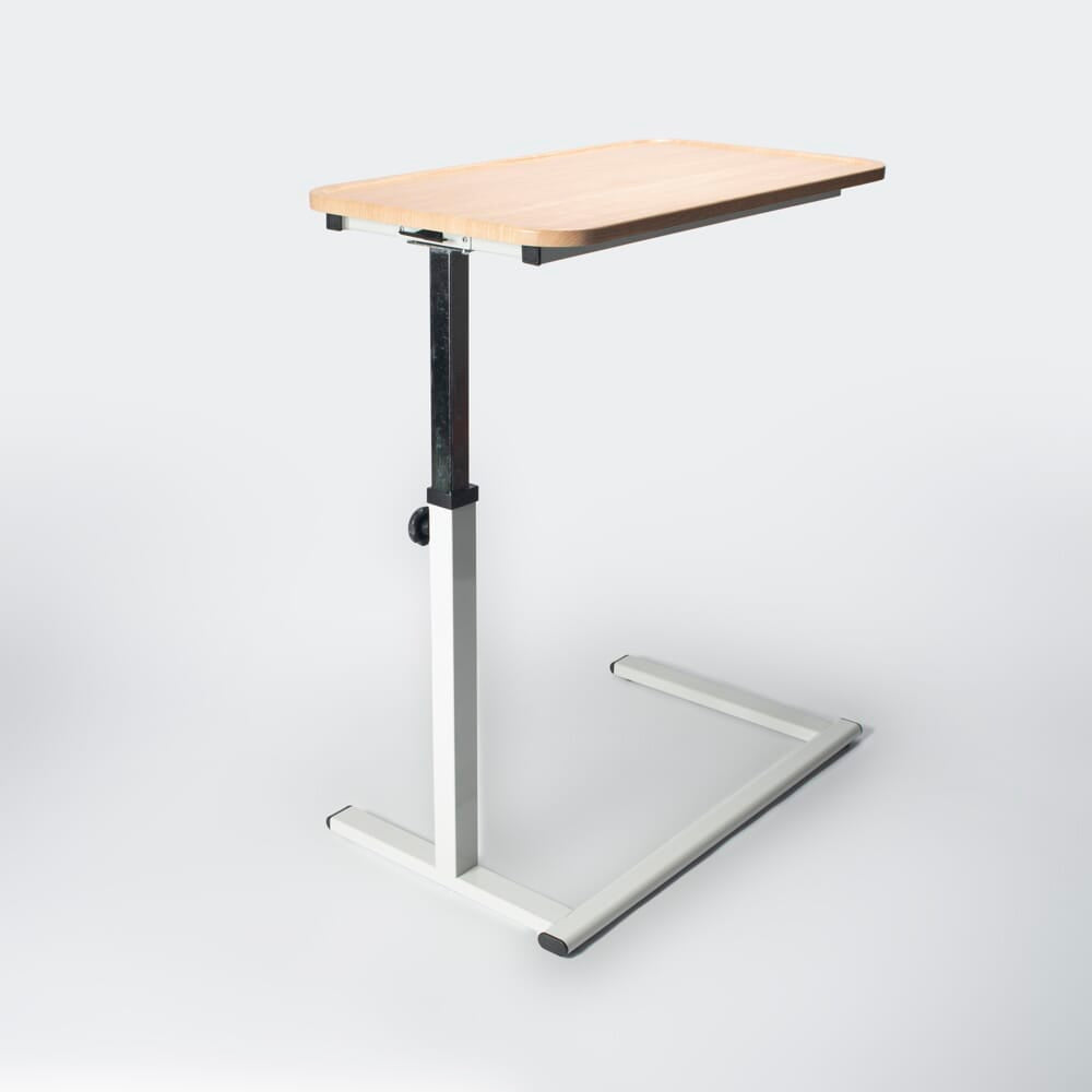 Side view of NRS Easylift Home Height Adjustable Overchair Table showing the tilting top and height-adjustable chrome stems.