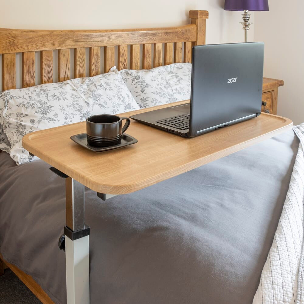 Side view of NRS Easylift Home Height Adjustable Overchair Table with the table top level at its lowest height.