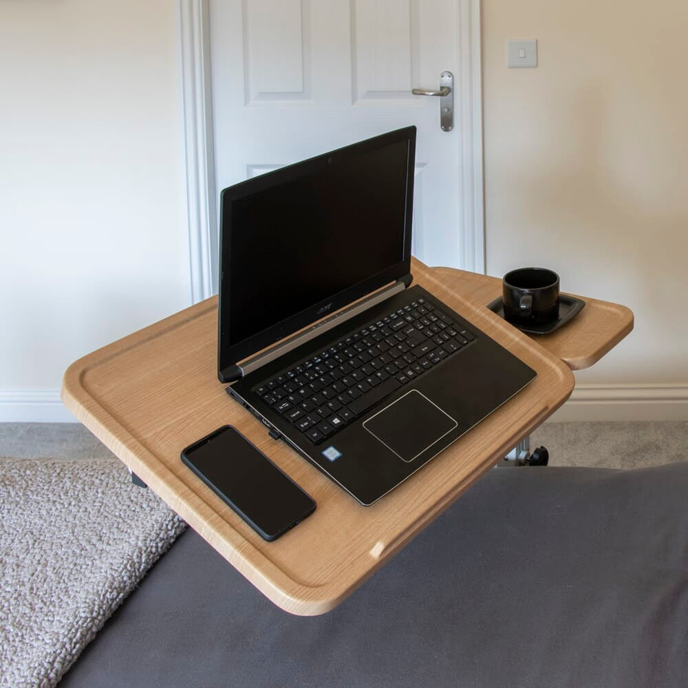 Close-up of a push button or knob on NRS Easylift Home Tilting Overbed Table's frame used for adjusting height or tilt.