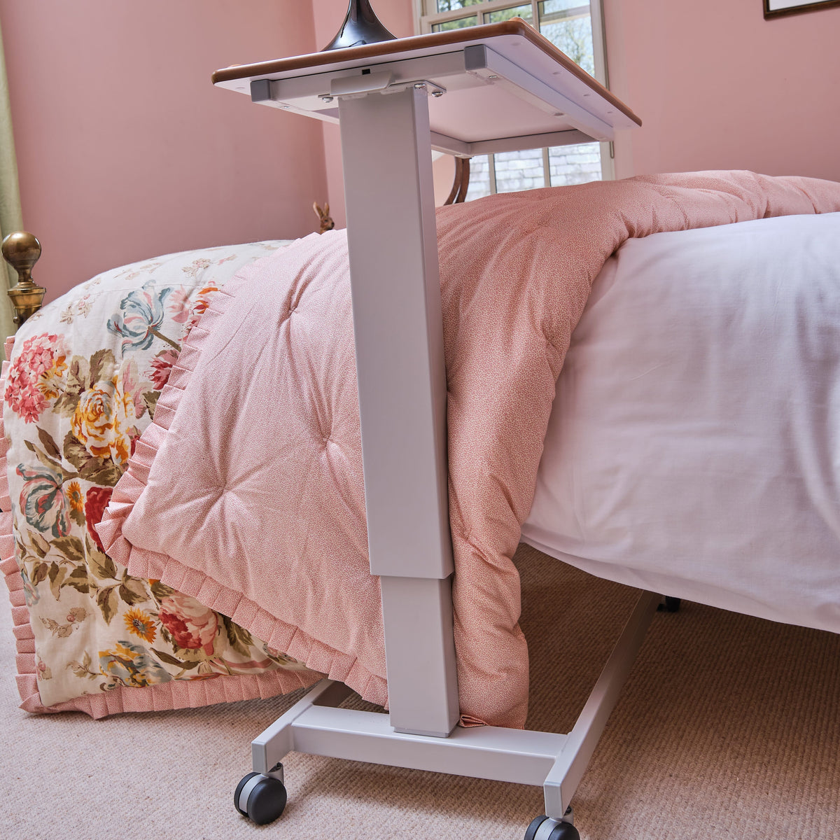 Close-up of the tubular base of NRS Easylift Overbed Table, highlighting the sturdy steel frame.