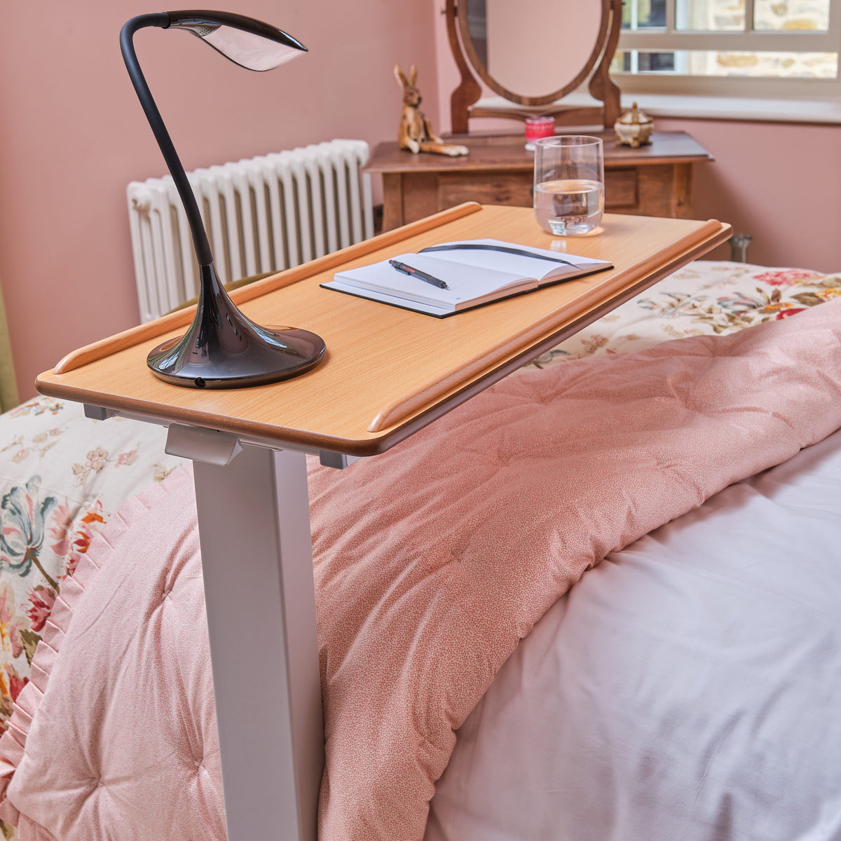 Close-up of the castor wheels on NRS Easylift Overbed Table, showing the smooth-rolling casters and brake mechanism.