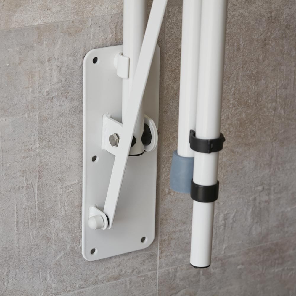 Lifestyle image of NRS Economy Drop Down Toilet Support Rail with Leg being used in a real-life setting.