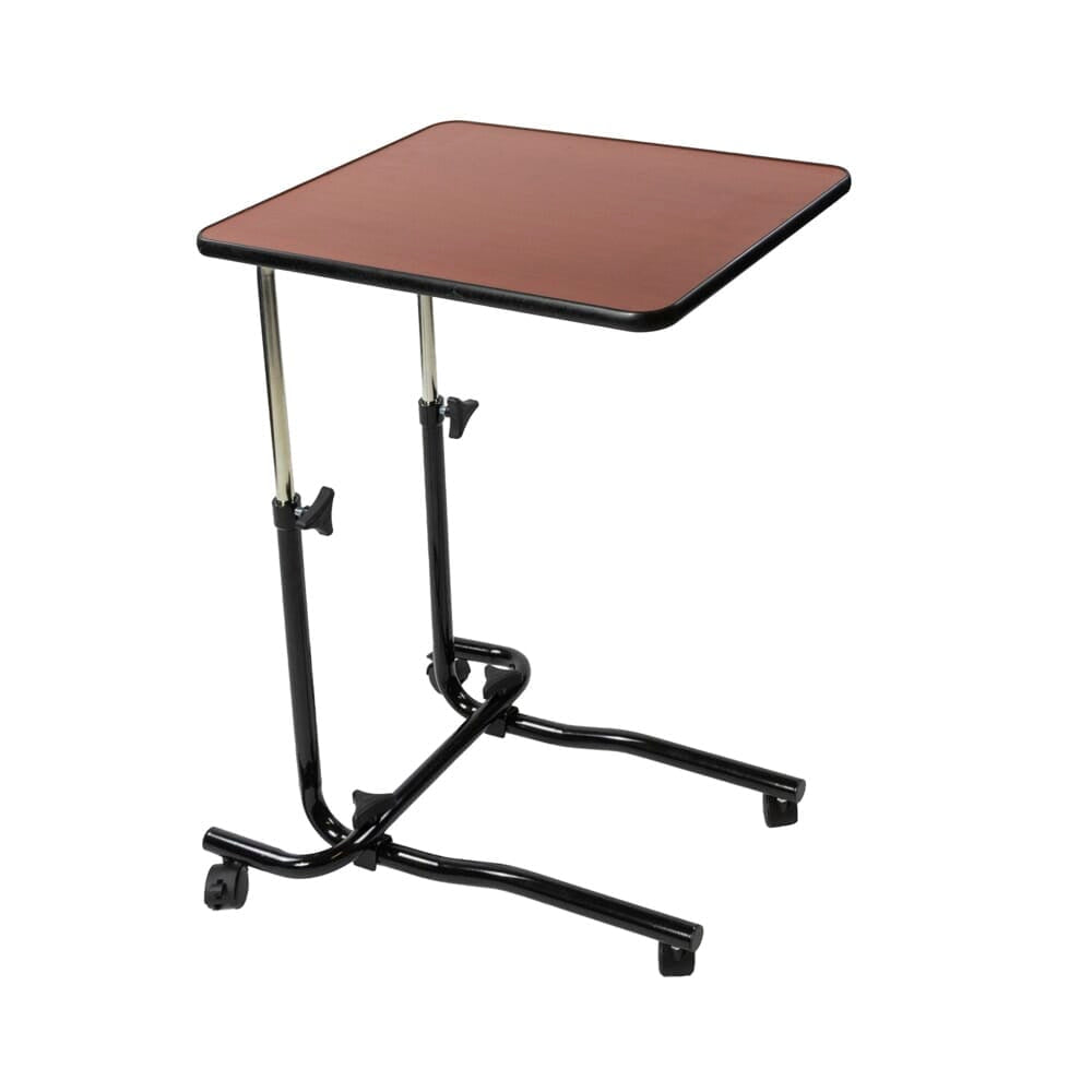 Angled view of NRS Economy Overbed Table with beech-effect tilting table top and white U-shaped base on castors against a neutral background.