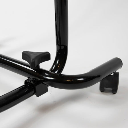 Side view of NRS Economy Overbed Table showing the tilting top and height-adjustable chrome stems.
