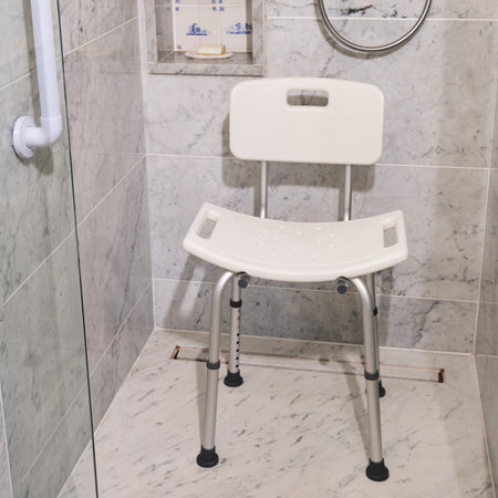 Angled view of NRS Economy Shower Chair with moulded seat, supportive backrest and height-adjustable legs on a plain background.