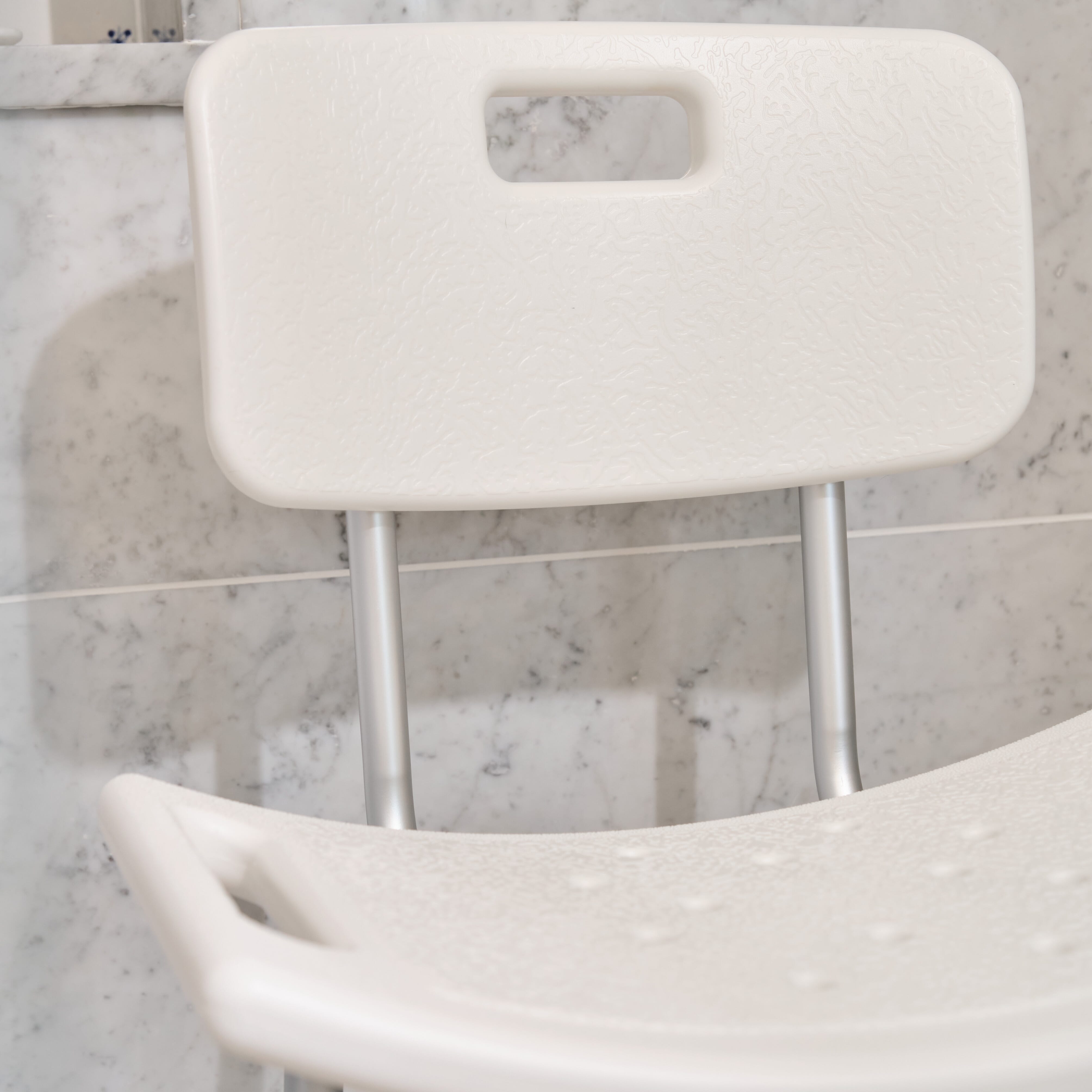 Front view of NRS Economy Shower Chair showing drainage holes in the seat and the supportive backrest design.