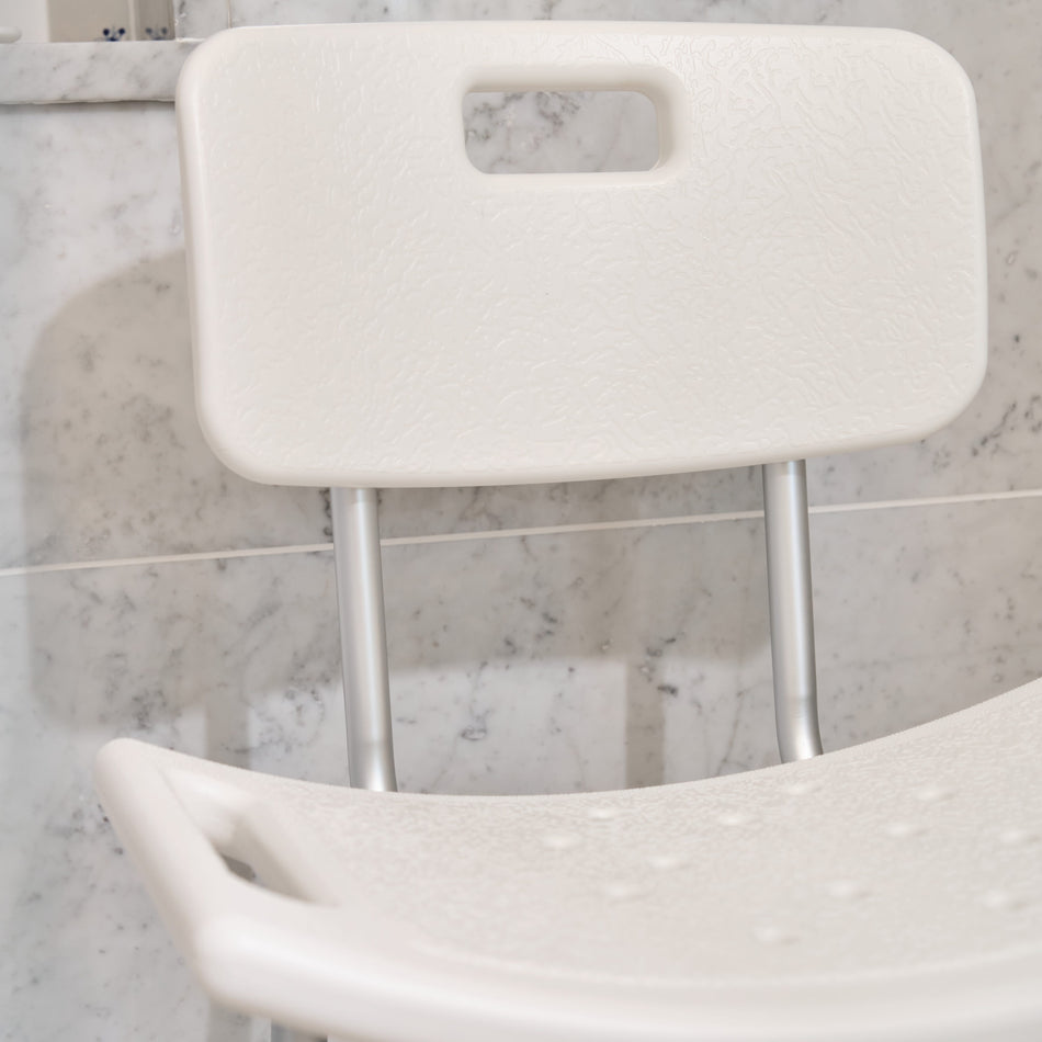 Front view of NRS Economy Shower Chair showing drainage holes in the seat and the supportive backrest design.