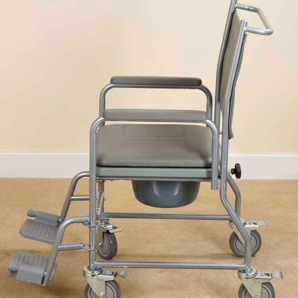 NRS Economy Wheeled Commode positioned in a home environment such as a bedroom or bathroom, demonstrating its discreet appearance.