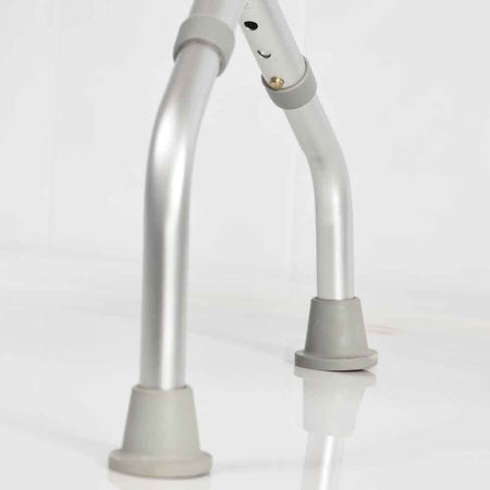 Close-up of a leg on NRS Foldable Shower Stool shower stool, showing the height adjustment holes and rubber ferrule.