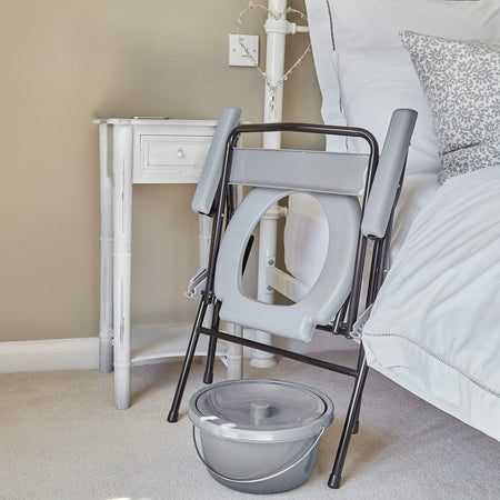 NRS Folding Commode with lid closed, highlighting the padded seat and discreet design.