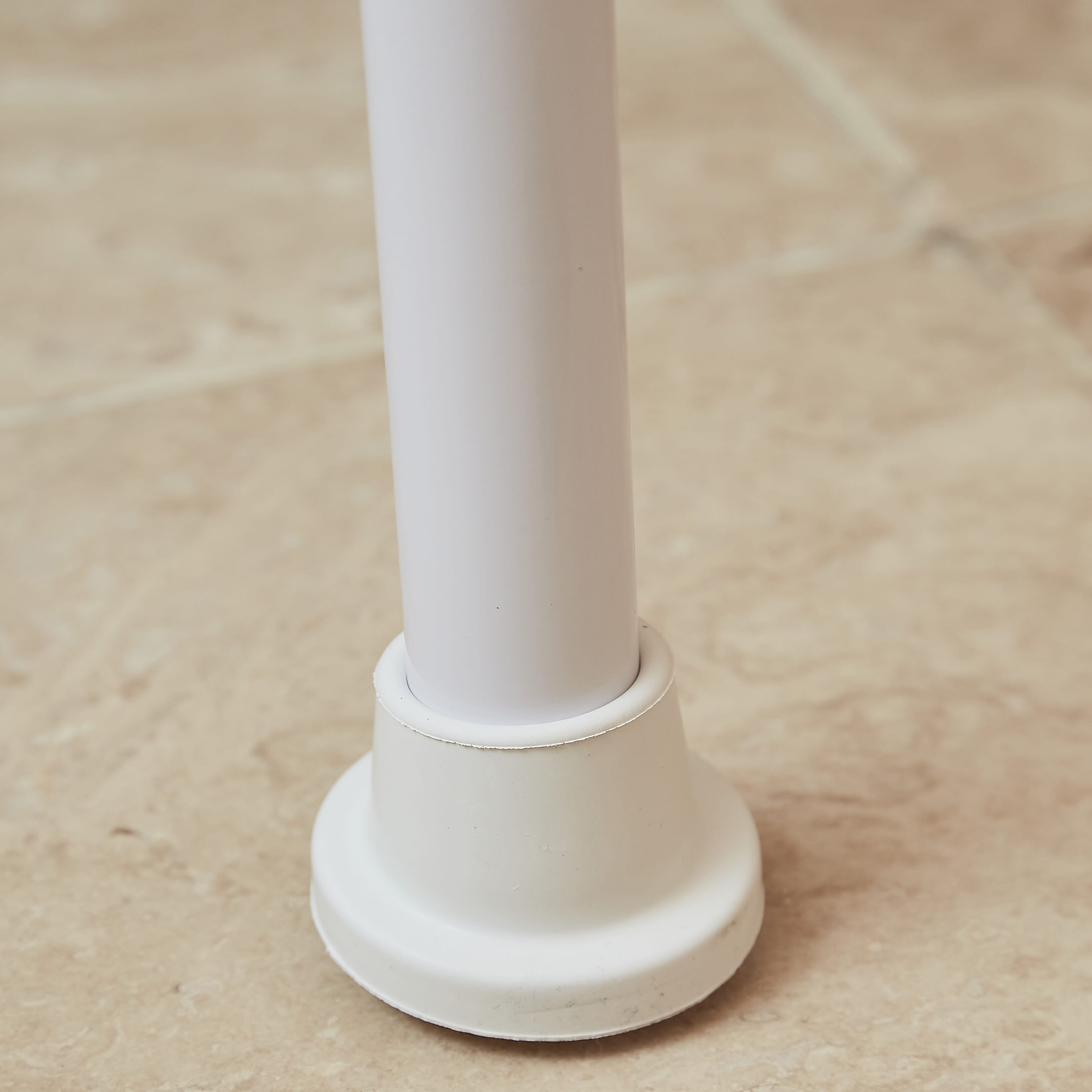 Close-up of a leg on NRS Folding Shower Chair, highlighting the height adjustment mechanism and non-slip rubber ferrule.
