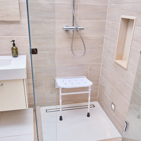 Image of NRS Folding Shower Seat with Legs on a plain background.