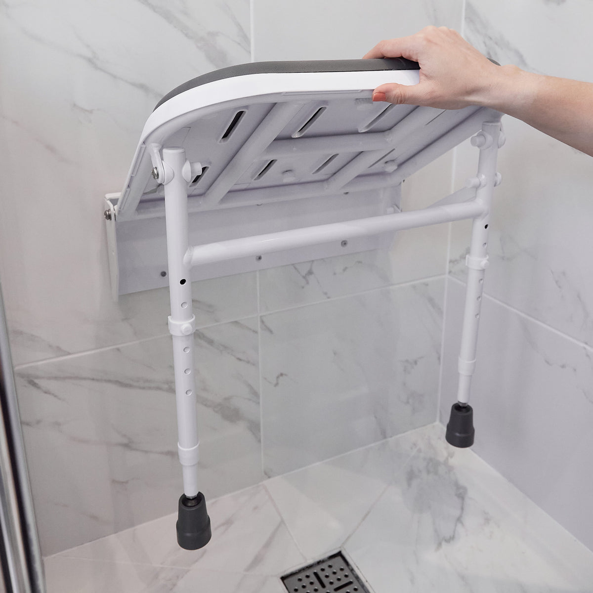Alternative view of NRS Folding Shower Seat with Legs and Padded Seat, showing different angle or usage.