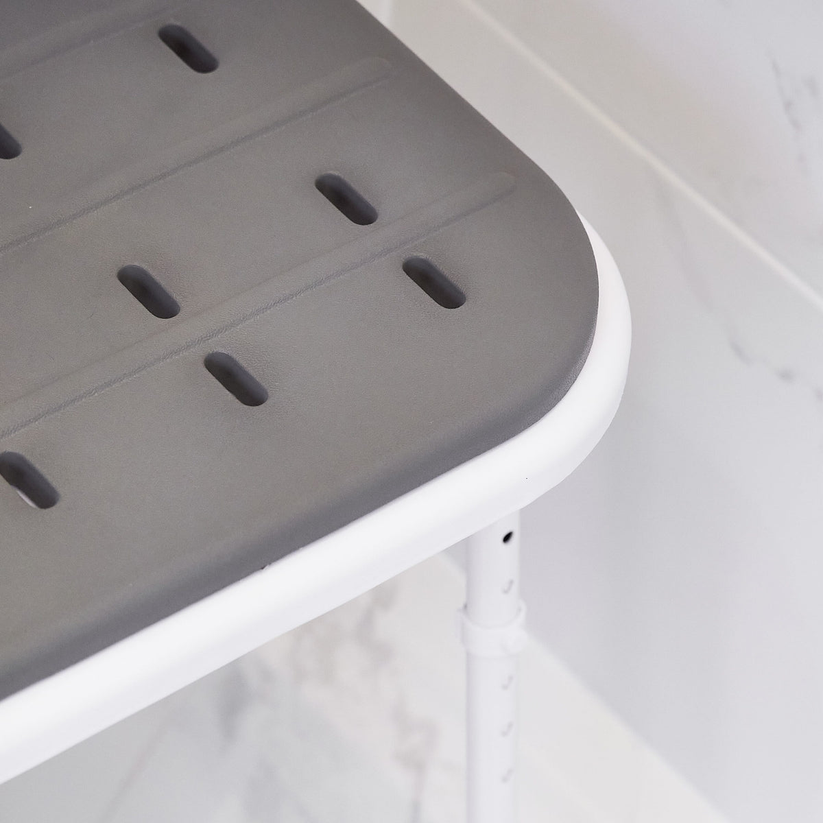 Lifestyle image of NRS Folding Shower Seat with Legs and Padded Seat being used in a real-life setting.