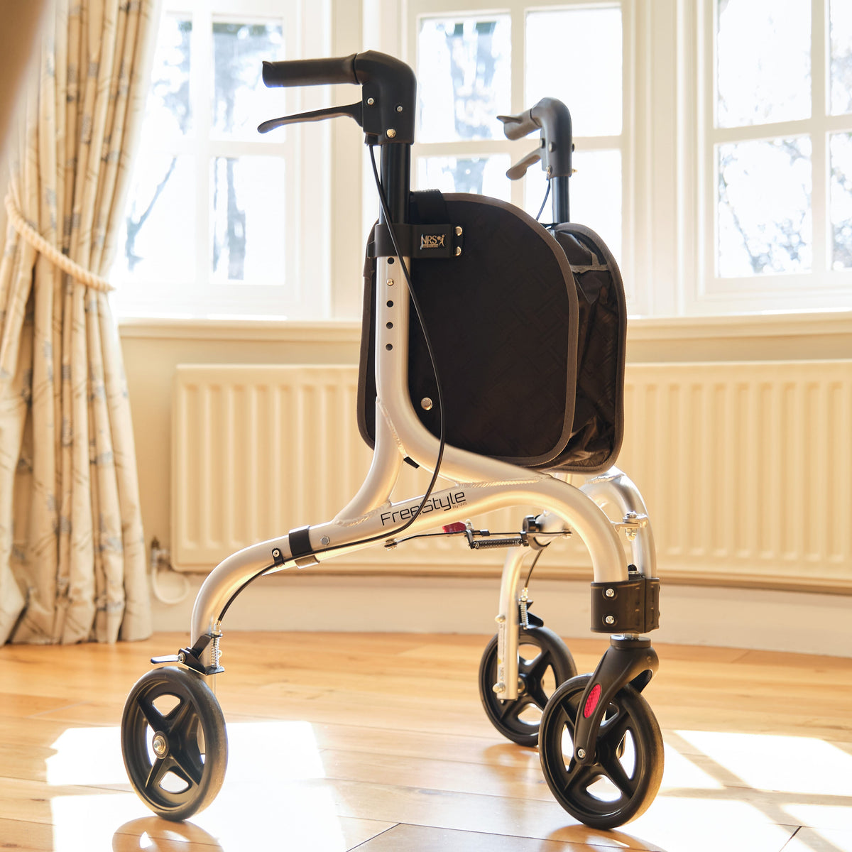 Front view of NRS Freestyle 3 Wheel Rollator three-wheel rollator showing handlebars, brake cables and single front wheel.