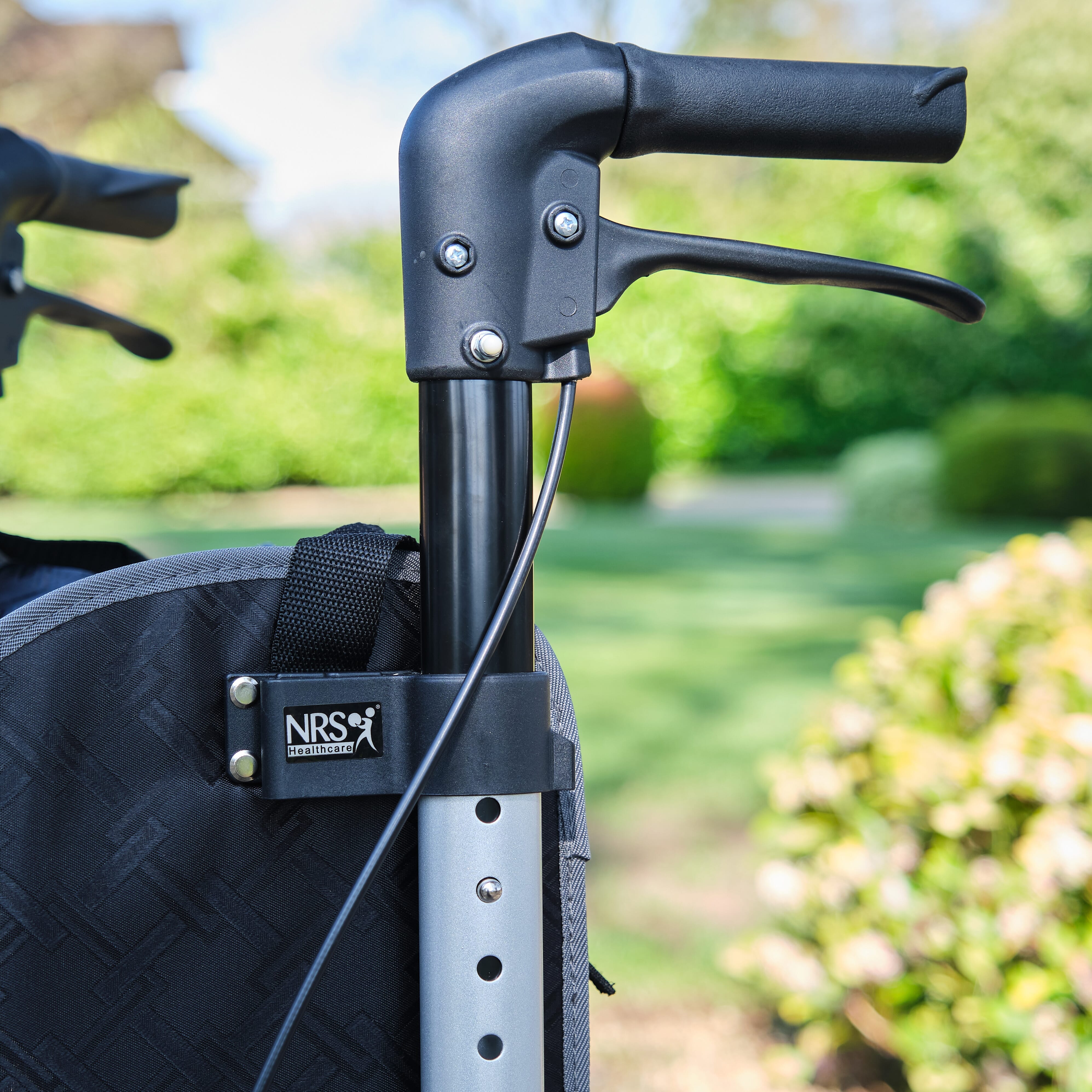 Close-up of the handle and brake lever on NRS Freestyle 3 Wheel Rollator rollator, emphasising the easy-grip design.
