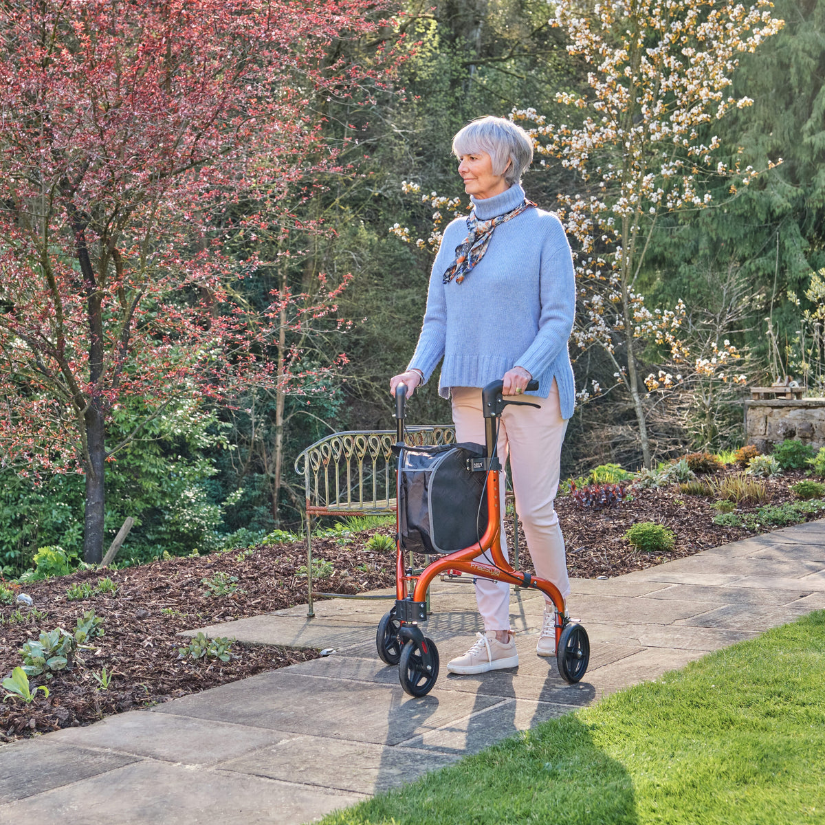 Front view of NRS Freestyle 3 Wheel Rollator three-wheel rollator showing handlebars, brake cables and single front wheel.