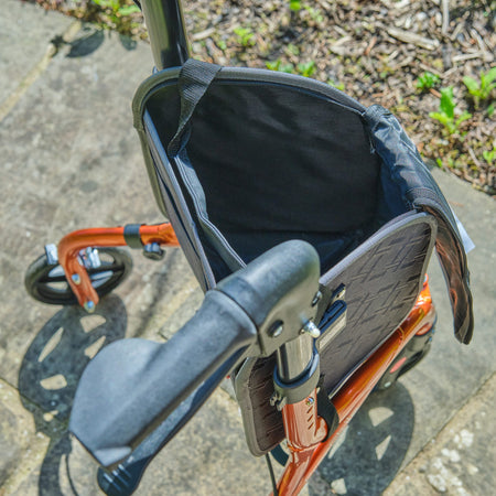 Side view of NRS Freestyle 3 Wheel Rollator three-wheel rollator, highlighting the triangular frame and rear wheels.