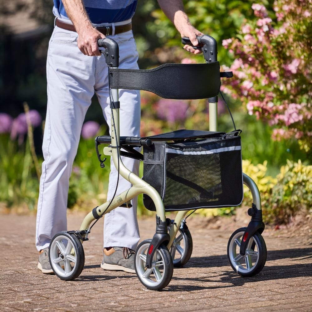 Angled view of NRS Freestyle 4 Wheel Rollator rollator with seat, padded backrest, storage bag and four wheels on a plain background.
