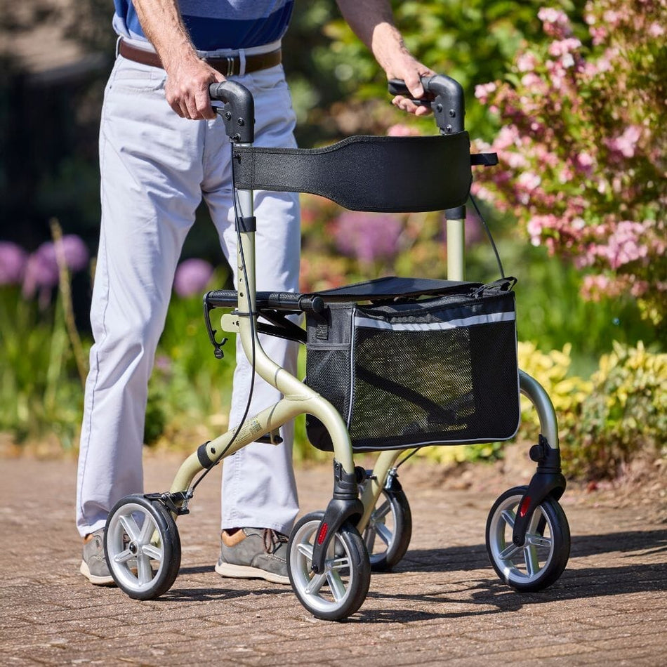 Angled view of NRS Freestyle 4 Wheel Rollator rollator with seat, padded backrest, storage bag and four wheels on a plain background.