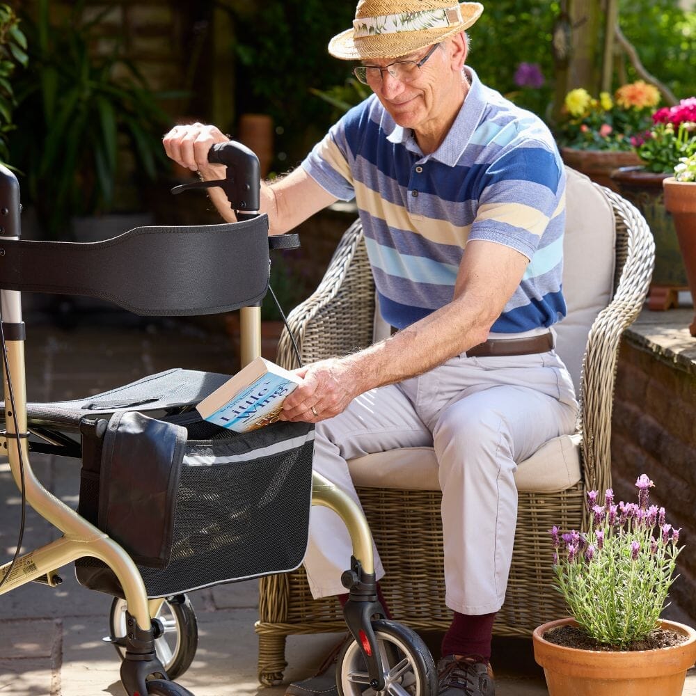 Fully folded NRS Freestyle 4 Wheel Rollator rollator lying flat, showing the triple-fold mechanism and compact size.
