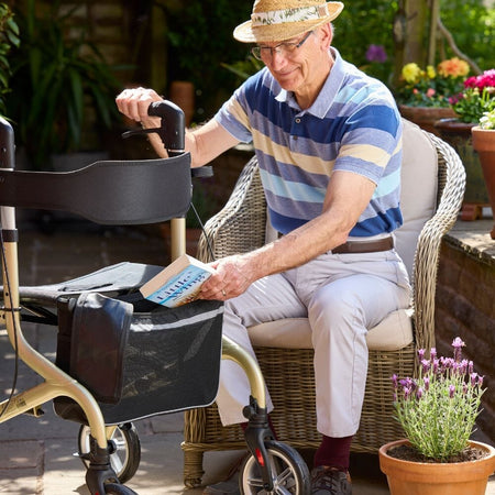 Fully folded NRS Freestyle 4 Wheel Rollator rollator lying flat, showing the triple-fold mechanism and compact size.
