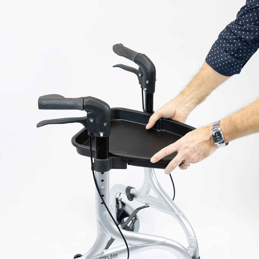 Fully folded NRS Freestyle Rollator Tray rollator lying flat, showing the triple-fold mechanism and compact size.