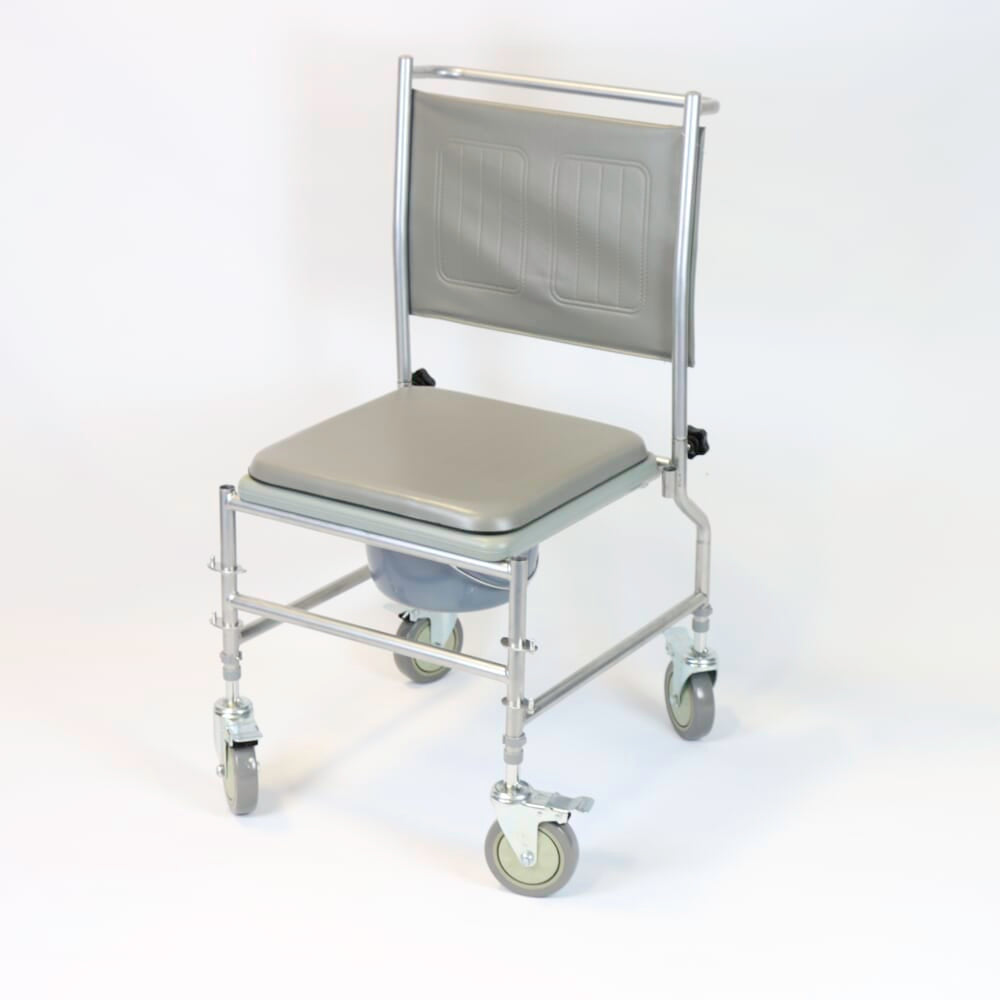 NRS Height Adjustable Wheeled Commode positioned in a home environment such as a bedroom or bathroom, demonstrating its discreet appearance.