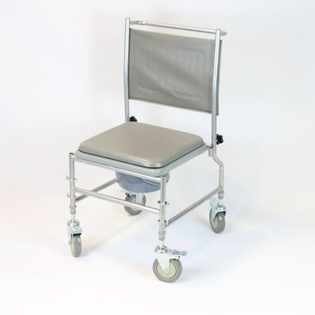 NRS Height Adjustable Wheeled Commode positioned in a home environment such as a bedroom or bathroom, demonstrating its discreet appearance.