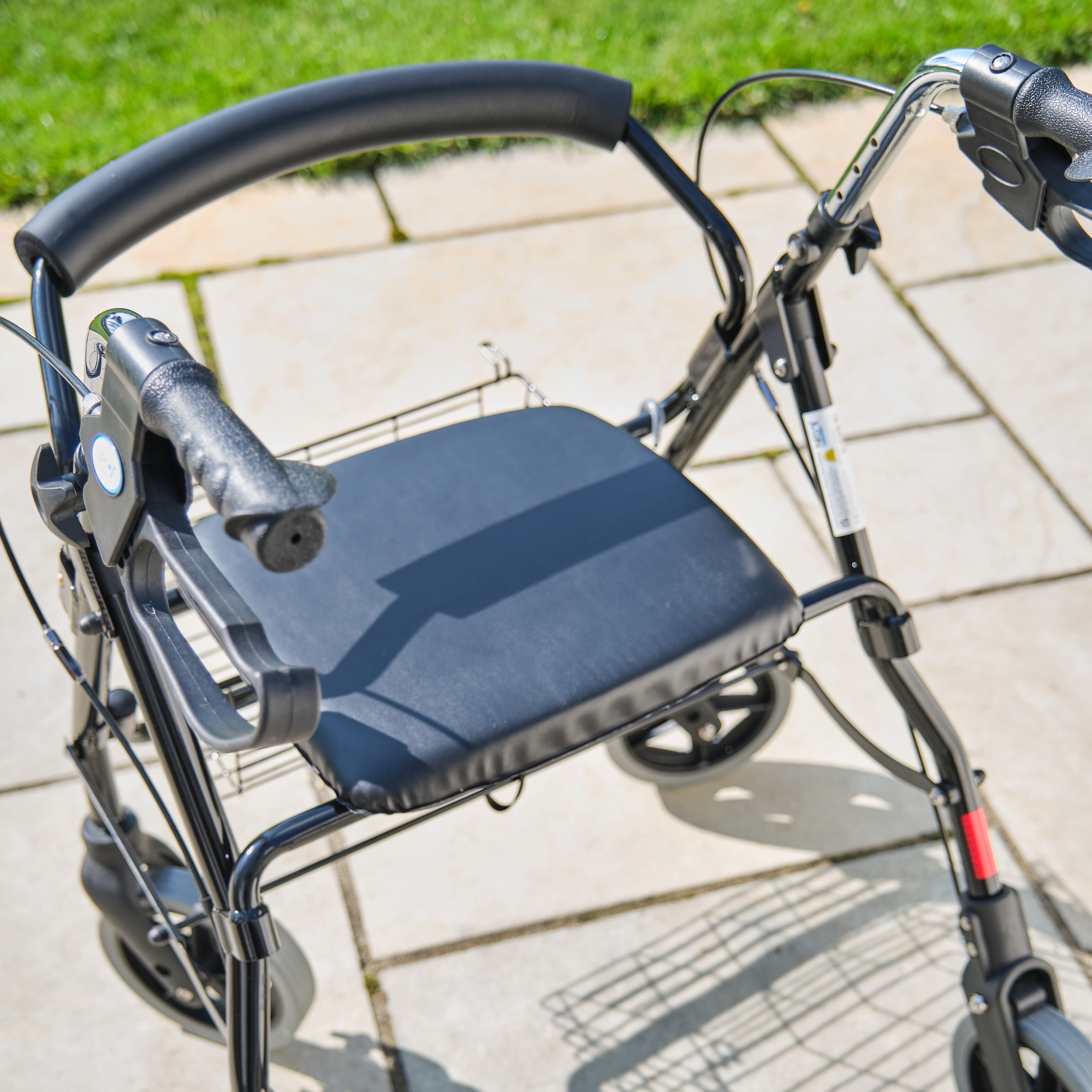 NRS Mobility Care Aluminium Rollator rollator folded from the front, demonstrating its slim, space-saving design.