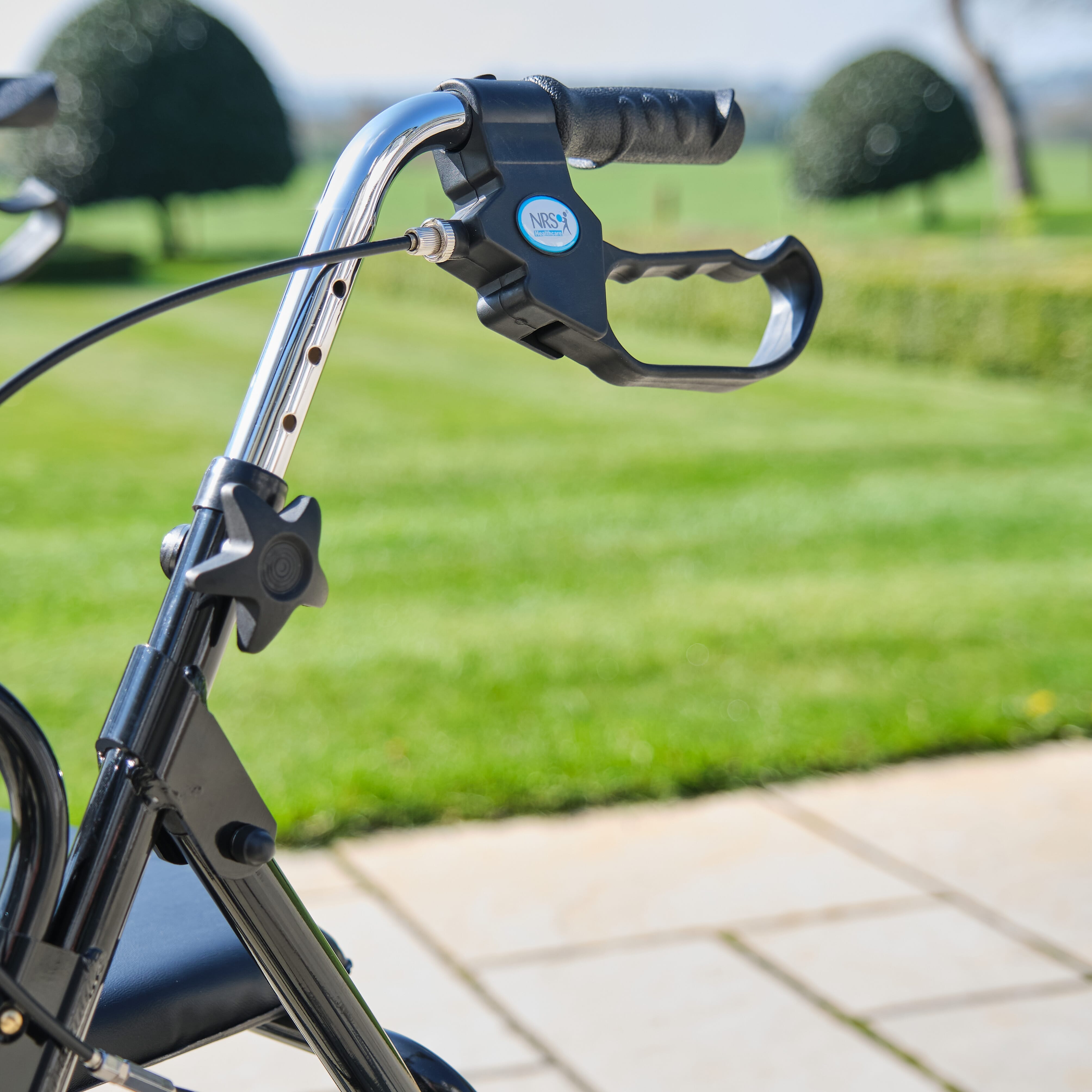 Fully folded NRS Mobility Care Aluminium Rollator rollator lying flat, showing the triple-fold mechanism and compact size.