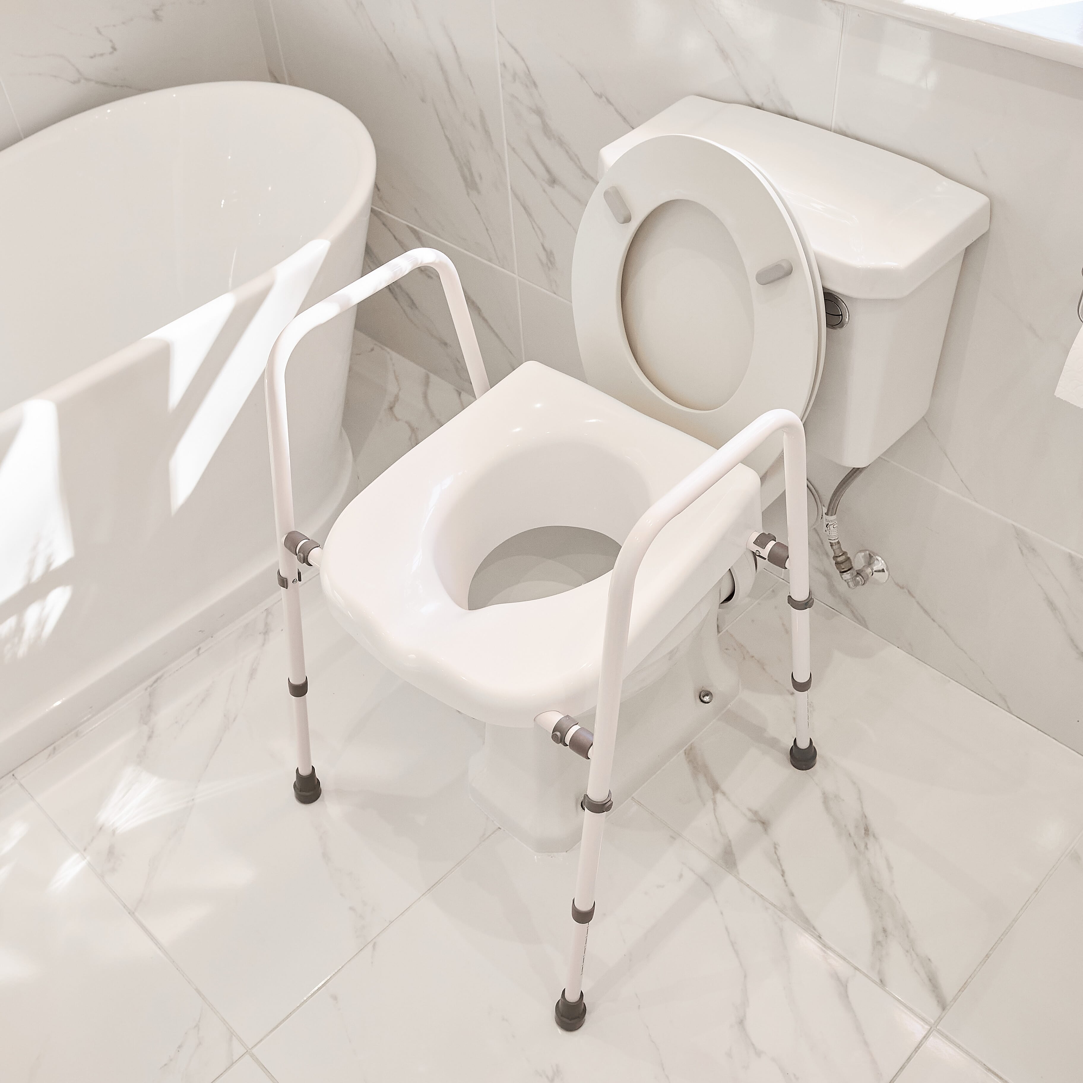 Diagram or packaging of NRS Mowbray Lite Toilet Frame Seat-Width Adjustable highlighting dimensions or features.