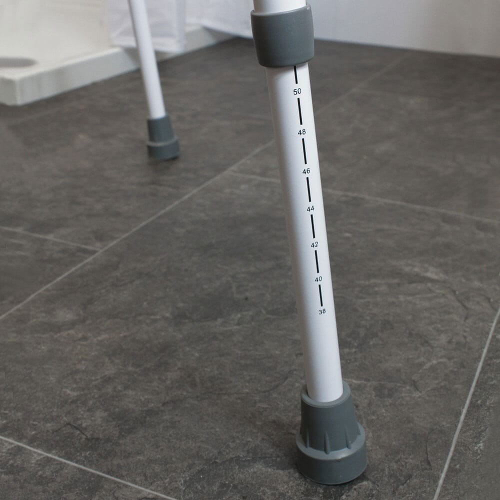 Diagram or packaging of NRS Mowbray Lite Toilet Frame Seat-Width Adjustable highlighting dimensions or features.