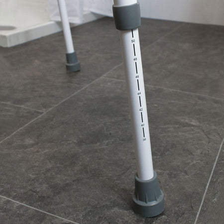 Diagram or packaging of NRS Mowbray Lite Toilet Frame Seat-Width Adjustable highlighting dimensions or features.