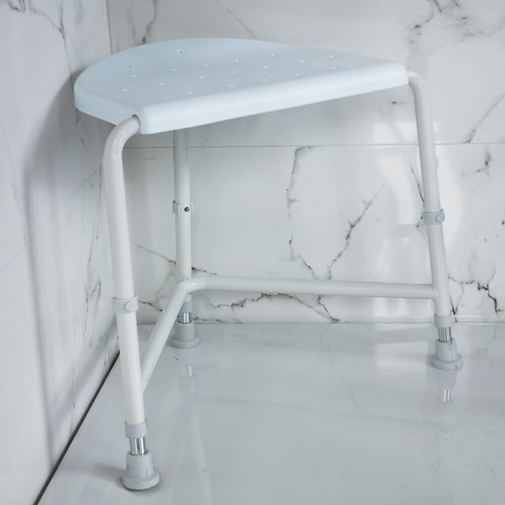 Angled view of NRS Nuvo Corner Shower Stool shower stool with moulded seat and height-adjustable legs on a plain background.