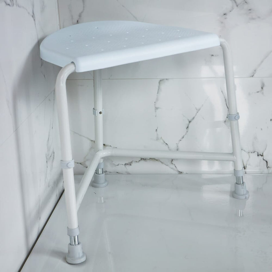 Angled view of NRS Nuvo Corner Shower Stool shower stool with moulded seat and height-adjustable legs on a plain background.