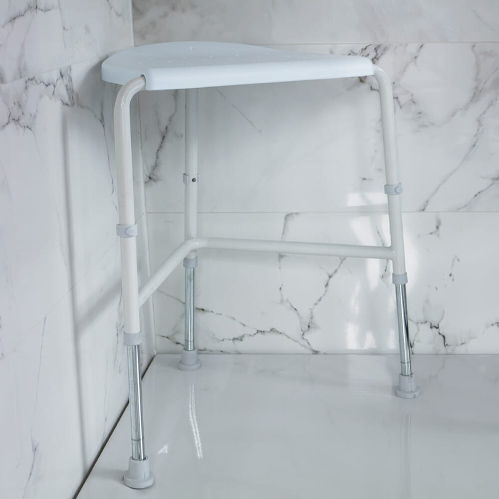 NRS Nuvo Corner Shower Stool placed in a shower to demonstrate safe, space-saving seating.
