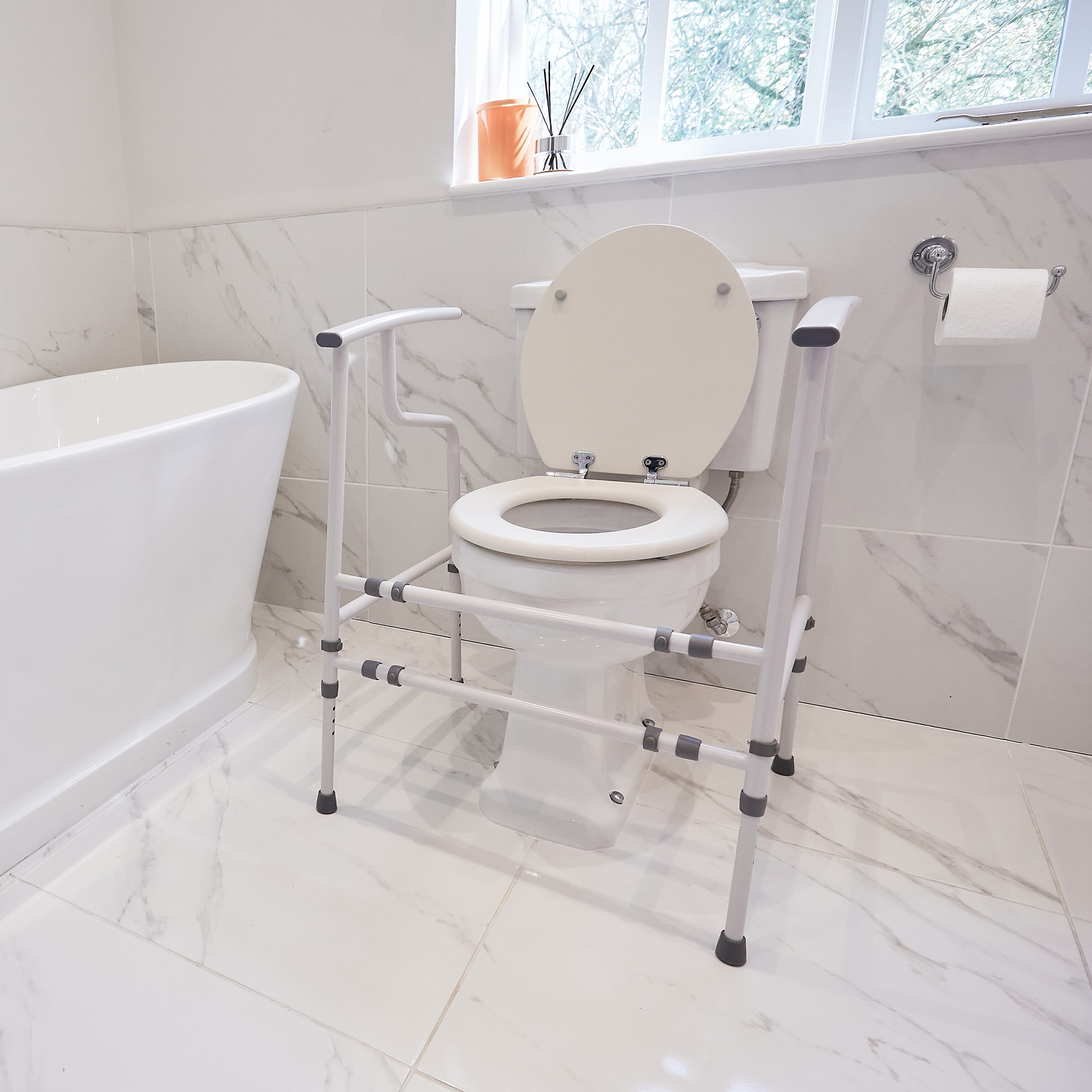 Lifestyle image of NRS Nuvo Open Back Toilet Frame being used in a real-life setting.