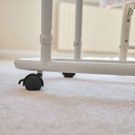 Side view of NRS Overbed Table showing the tilting top and height-adjustable chrome stems.