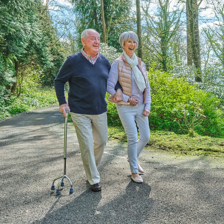 NRS Quad Base Walking Stick walking stick in use by a person, demonstrating balance and support.