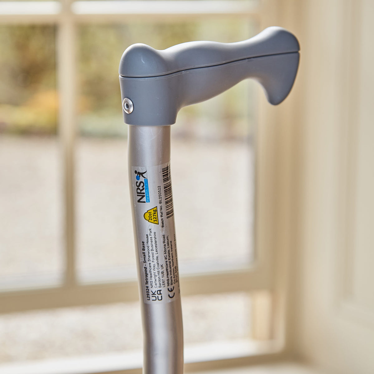 Close-up of the handle on NRS Quad Base Walking Stick walking stick, highlighting the ergonomic grip.