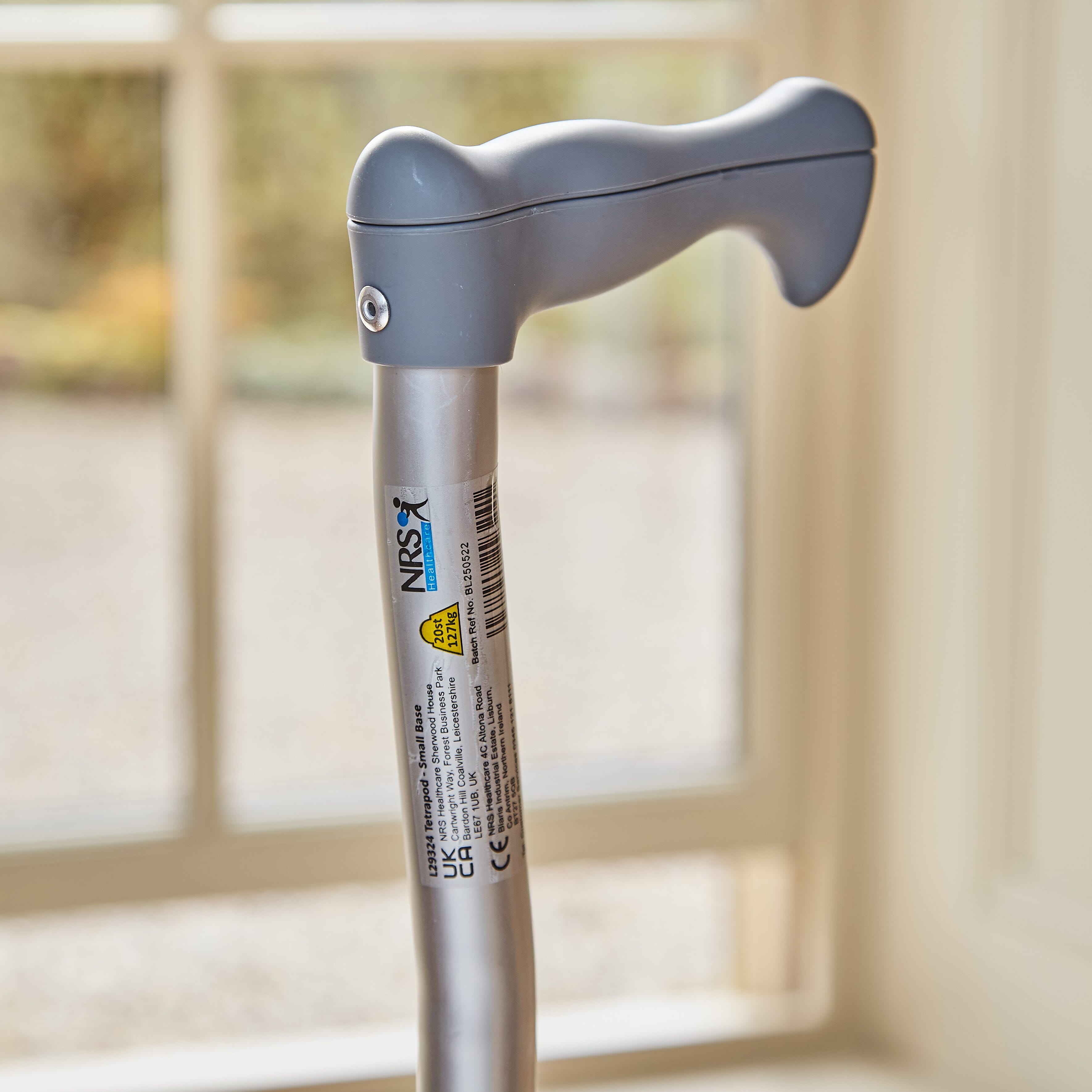 Close-up of the handle on NRS Quad Base Walking Stick walking stick, highlighting the ergonomic grip.