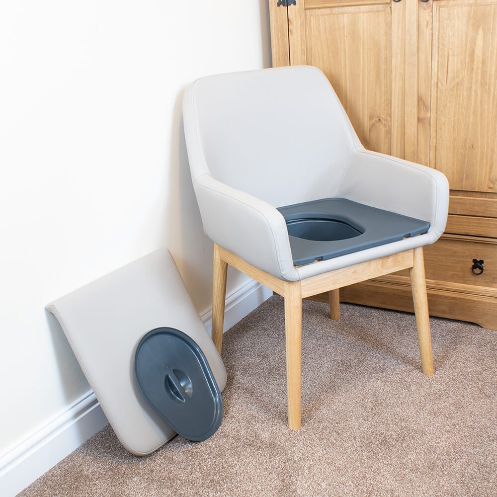 NRS Sanctuary Commode with lid closed, highlighting the padded seat and discreet design.