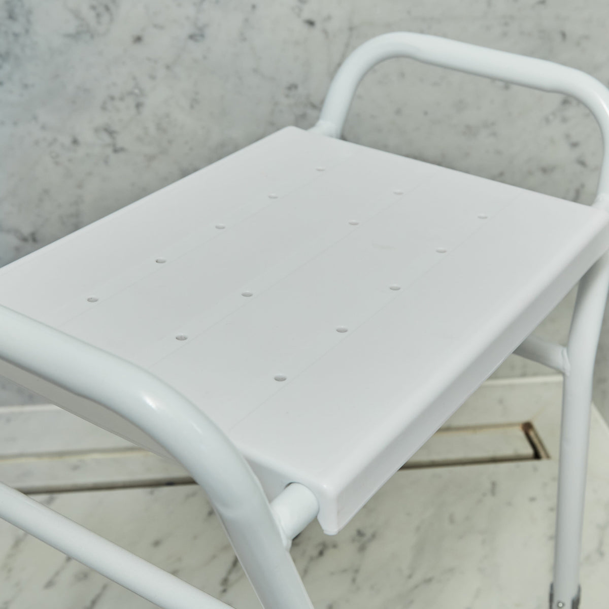 Top view of NRS Shower Stool With Handles showing drainage holes in the seat for quick water runoff.