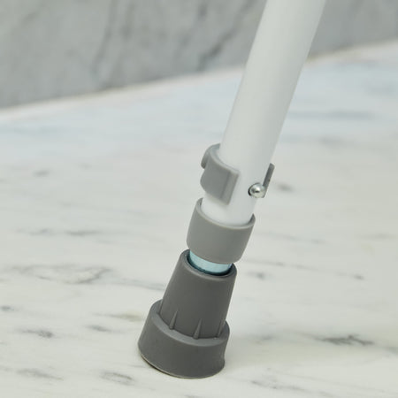 Close-up of a leg on NRS Shower Stool With Handles shower stool, showing the height adjustment holes and rubber ferrule.