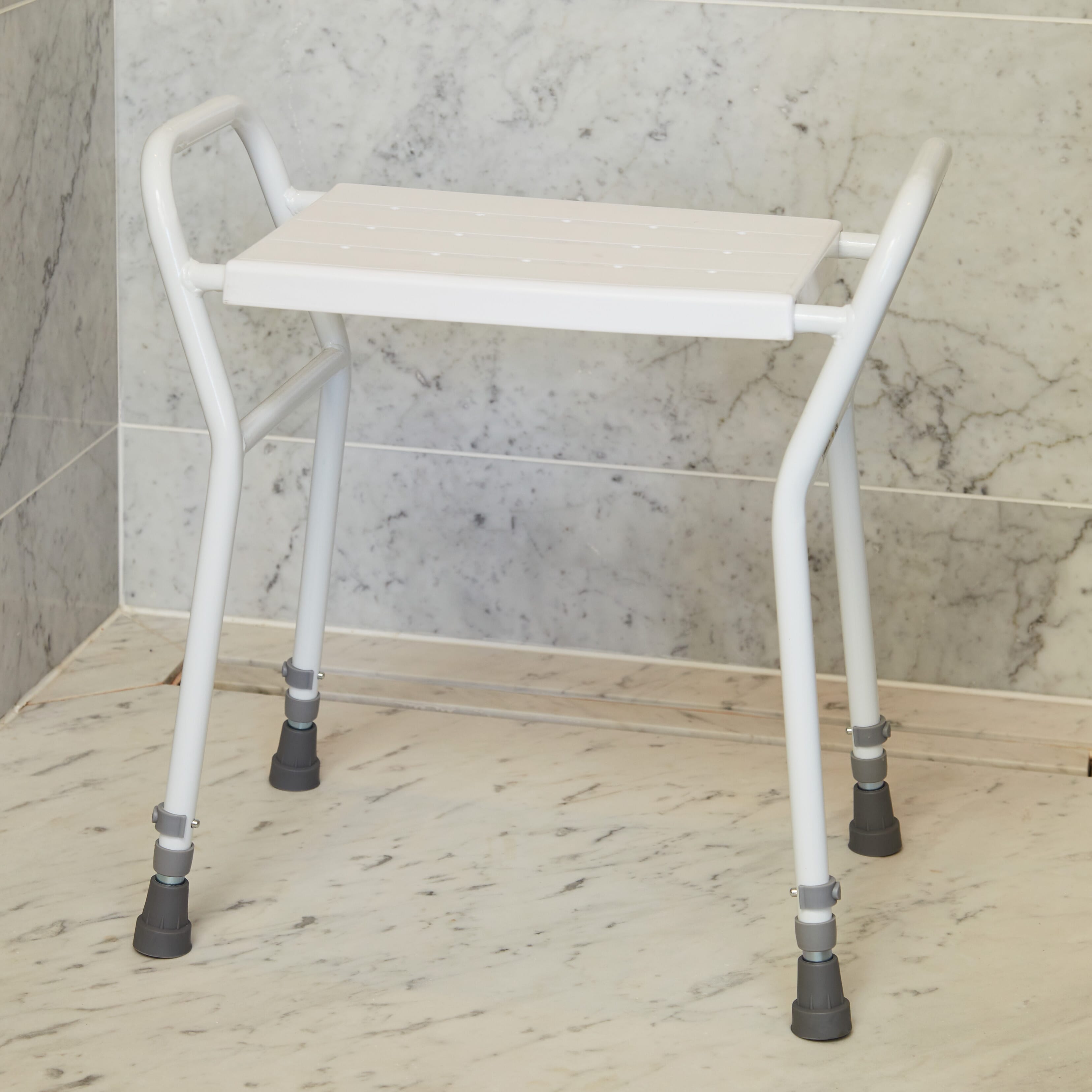 NRS Shower Stool With Handles placed in a shower to demonstrate safe, space-saving seating.
