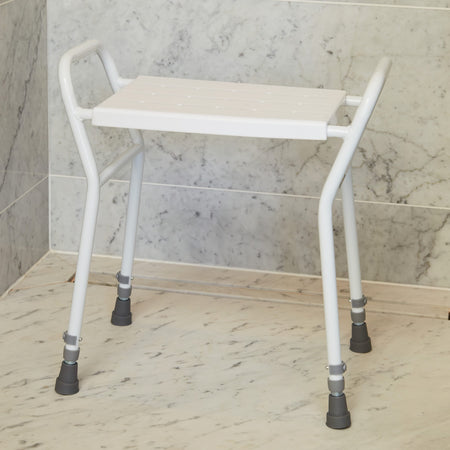 NRS Shower Stool With Handles placed in a shower to demonstrate safe, space-saving seating.