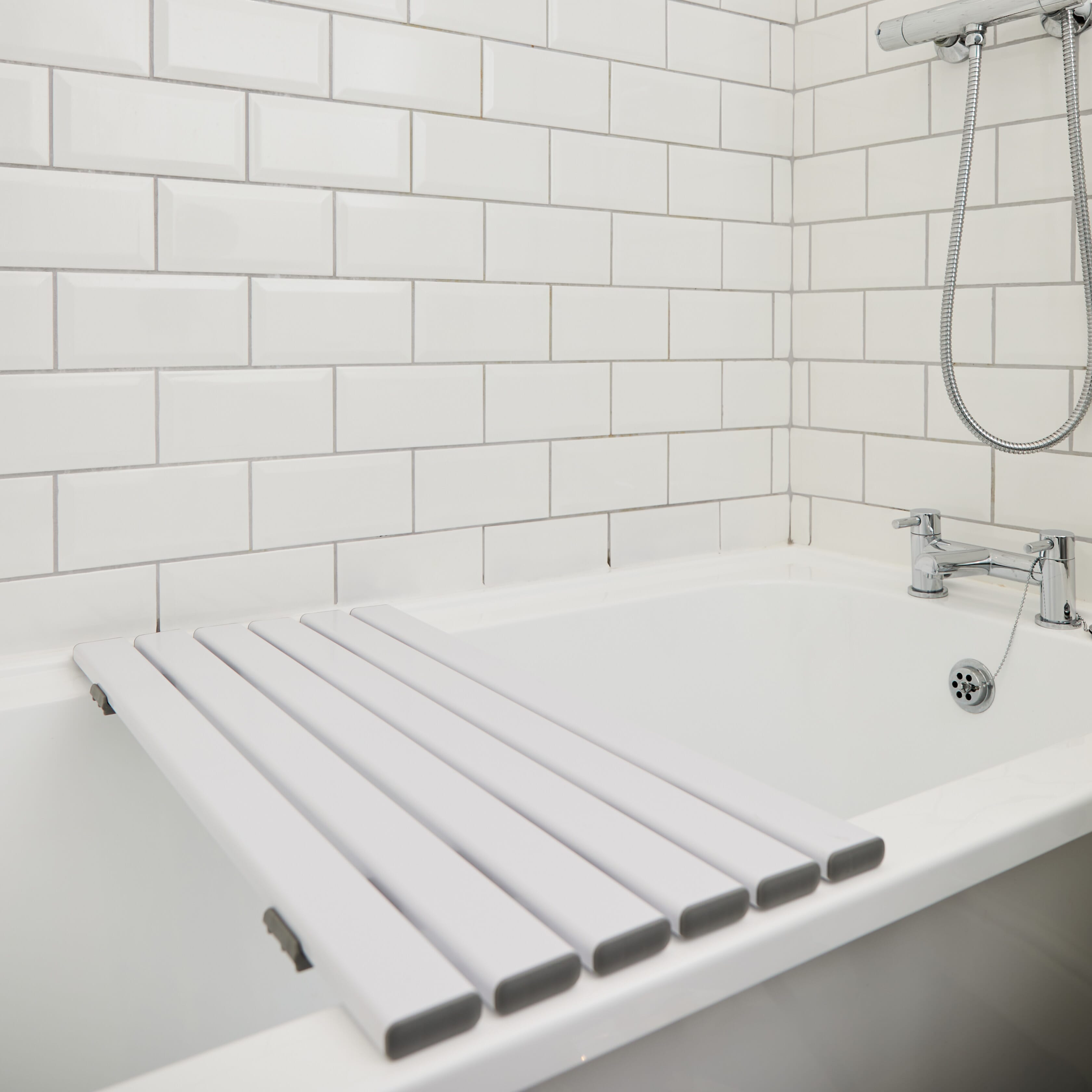 Full view of NRS Slatted Shower Board bath board showing slatted seat, integral handle and adjustable brackets on a plain background.